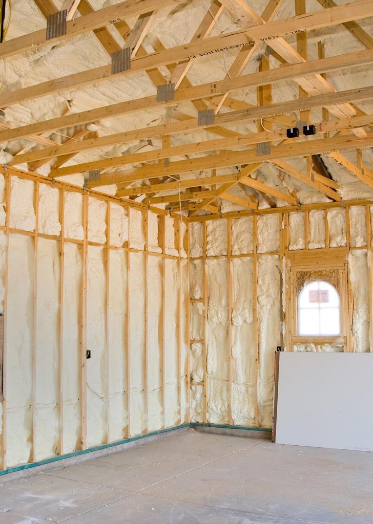 A room at a newly constructed home is sprayed with liquid insulating foam before the drywall is added.