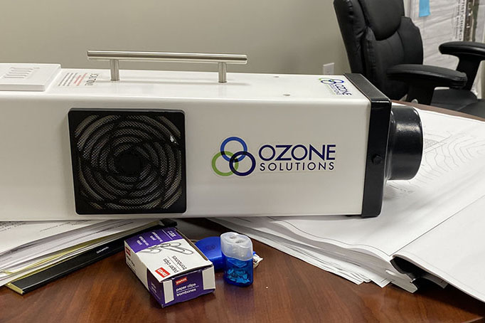 Ozone Solutions ozone machine sitting on a desk.