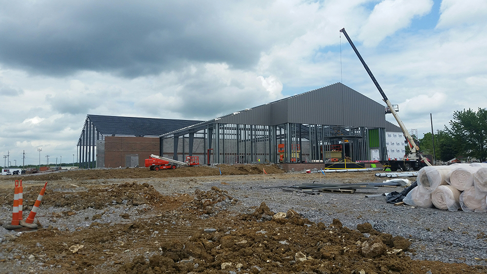 The interior of an empty metal building during its construction.