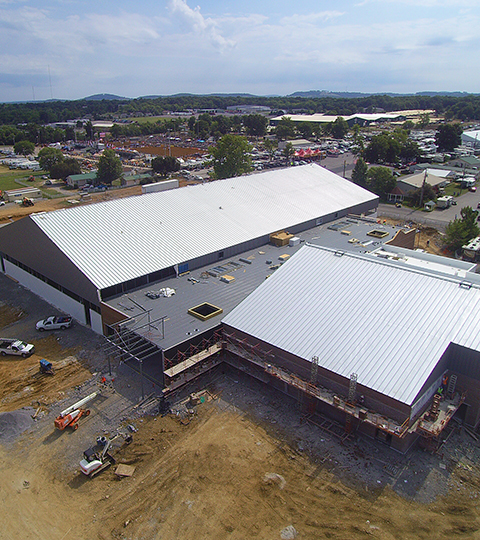 Drone footage of a metal building during its construction.