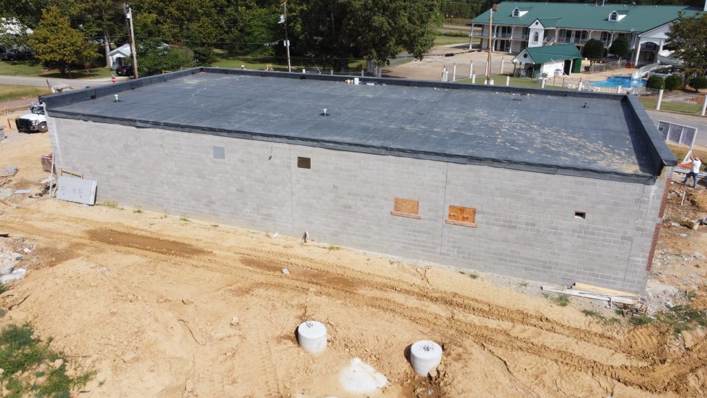 Exterior of the new Chester County 911 building under construction. A house with green roof and some trees can be seen on the upper portion.